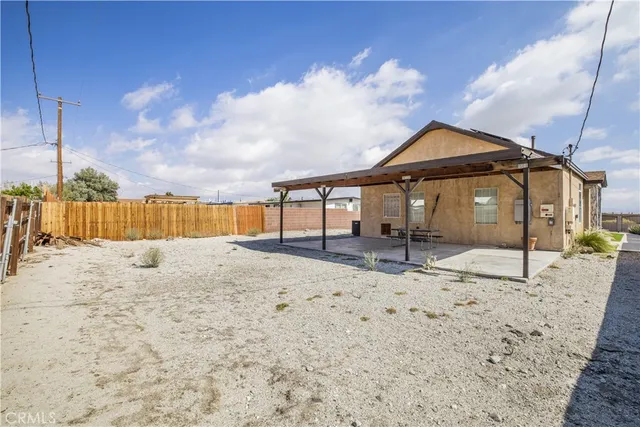a view of wooden fence and a big yard