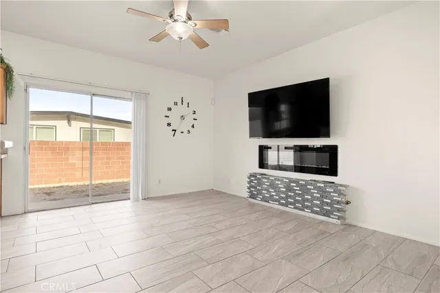 a view of livingroom with furniture flat screen tv and windows