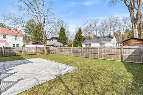 a view of yard with swimming pool and trees