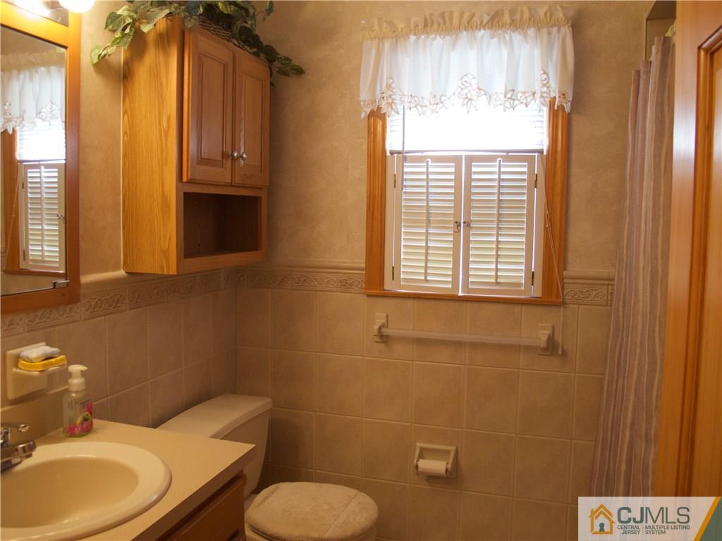 34 Montview Road Edison, NJ 08837 - Photo 14 of 23 a bathroom with a toilet sink vanity and mirror