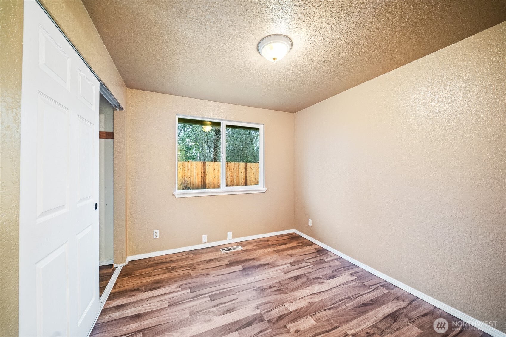 809 Cardigan Street Northwest Olympia, WA 98502 - Photo 18 of 30 an empty room with wooden floor and windows