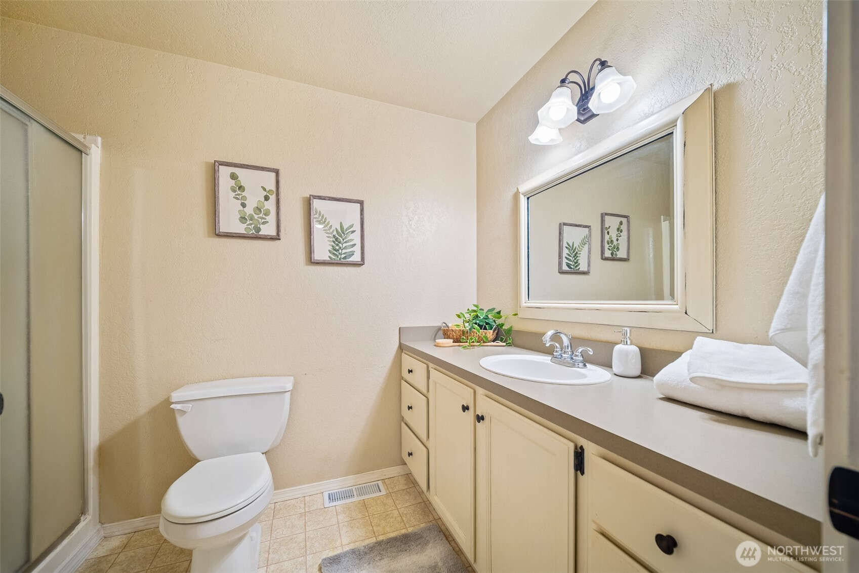 809 Cardigan Street Northwest Olympia, WA 98502 - Photo 22 of 30 a bathroom with a toilet sink and mirror