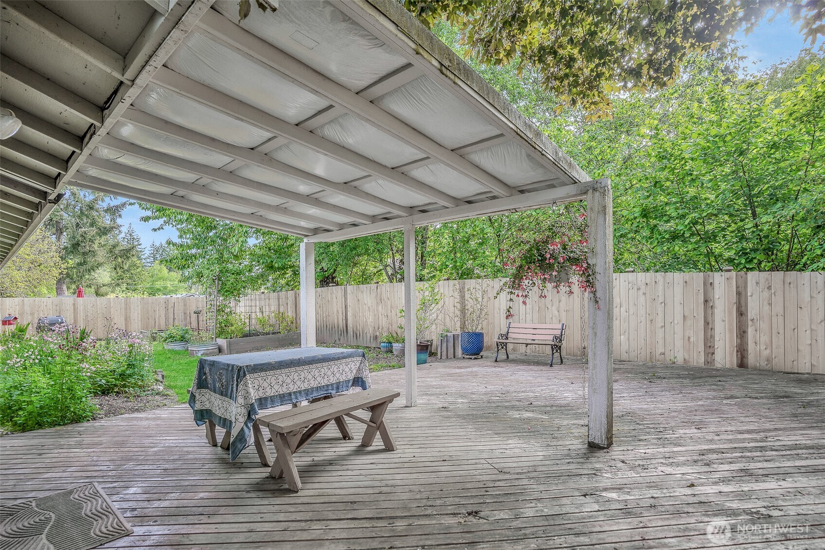 809 Cardigan Street Northwest Olympia, WA 98502 - Photo 25 of 30 a backyard of a house with wooden fence and floor to ceiling windows