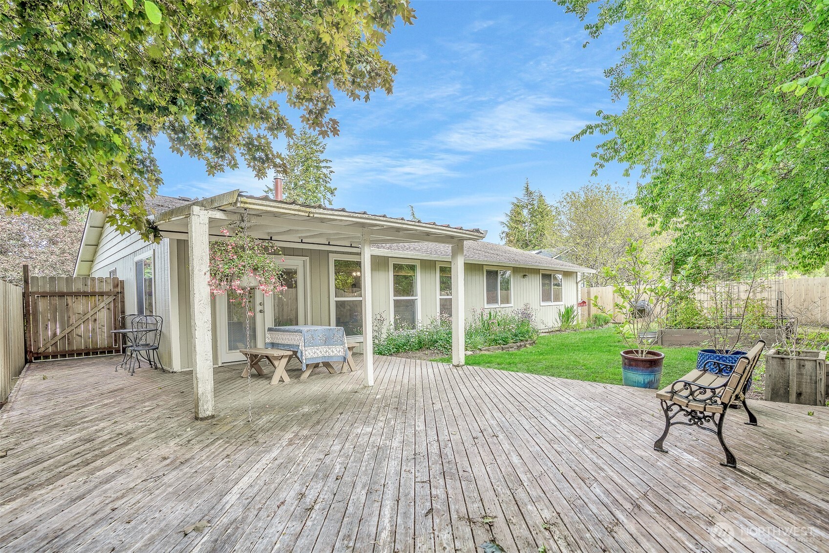 809 Cardigan Street Northwest Olympia, WA 98502 - Photo 26 of 30 a view of a house with a chairs and table on the wooden deck
