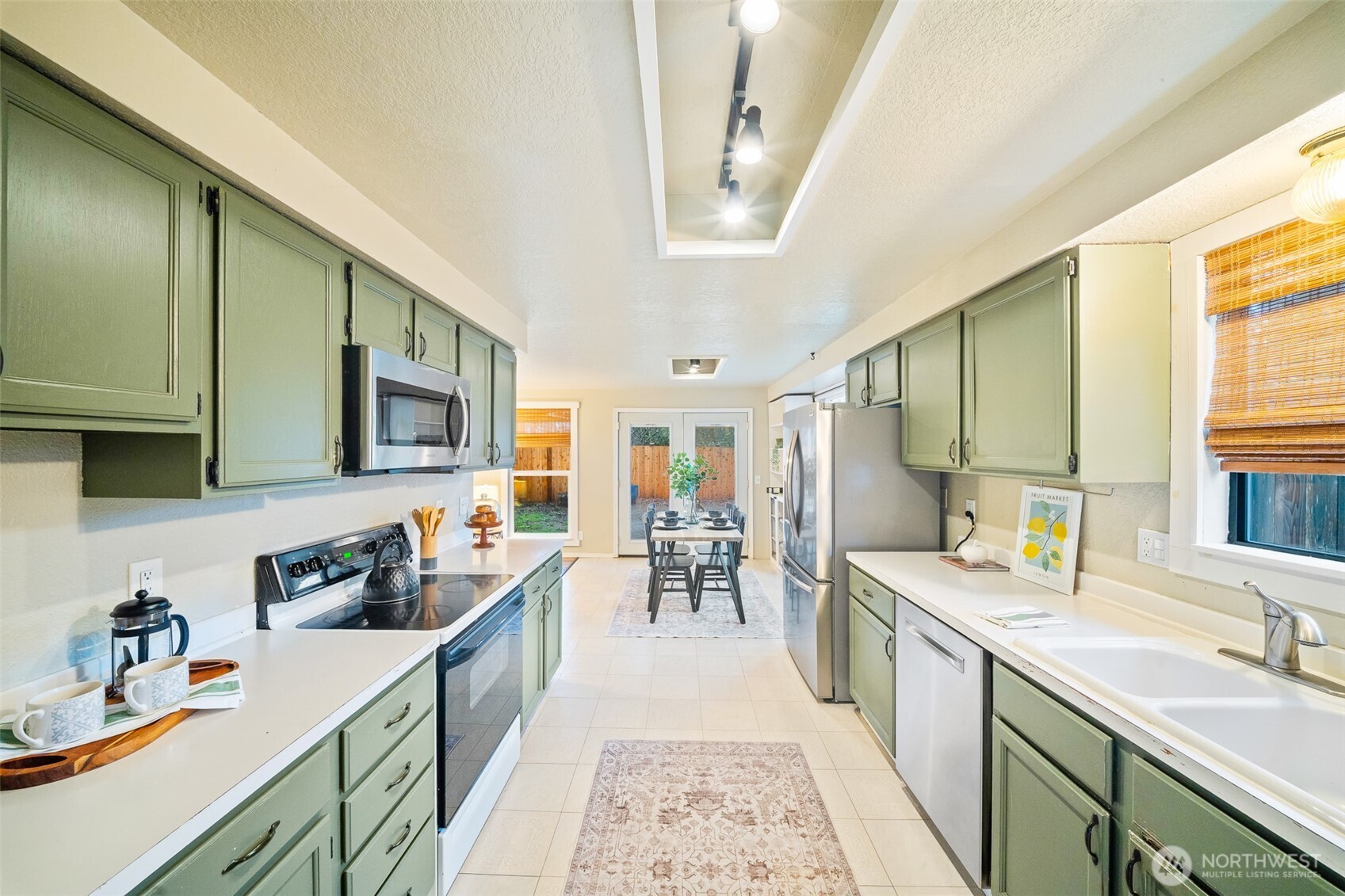 809 Cardigan Street Northwest Olympia, WA 98502 - Photo 9 of 30 a kitchen with stainless steel appliances granite countertop sink stove top oven and cabinets