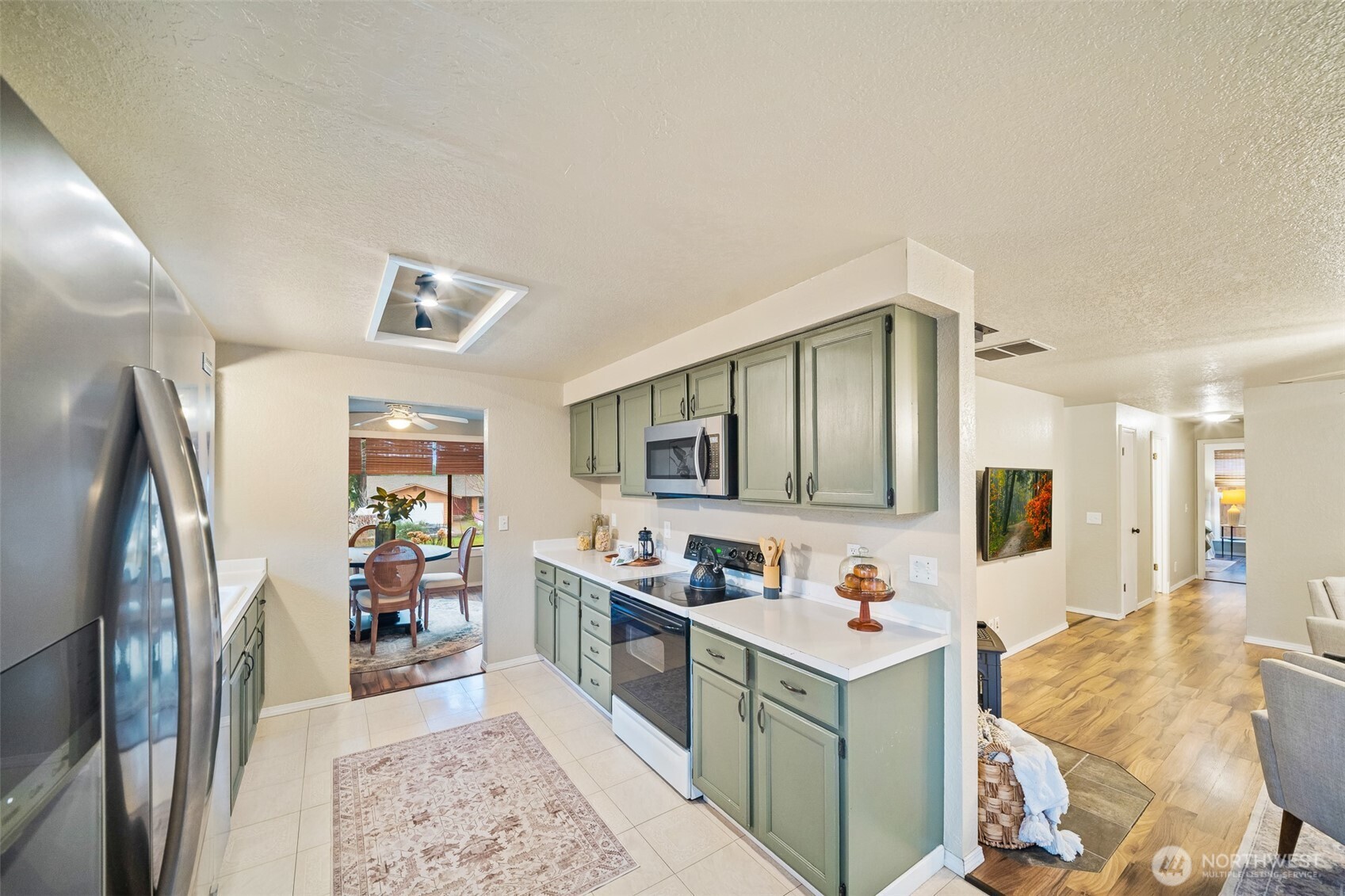 809 Cardigan Street Northwest Olympia, WA 98502 - Photo 10 of 30 a kitchen with stainless steel appliances granite countertop a refrigerator stove and sink