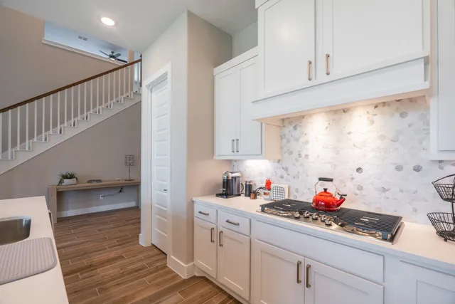 a kitchen with sink cabinets and appliances