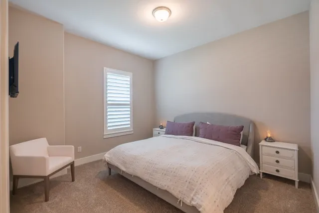 a bedroom with a bed and a chair