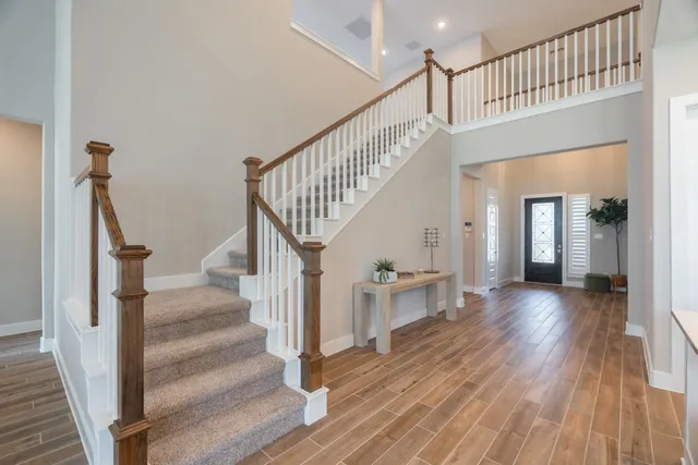 a view of staircase with wooden floor and a chandelier