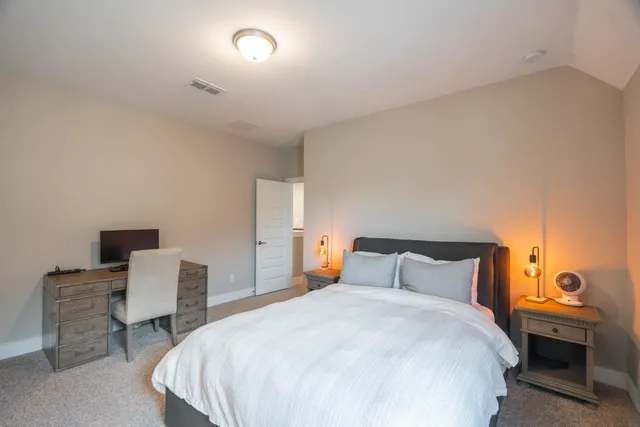 a bedroom with a bed and chair