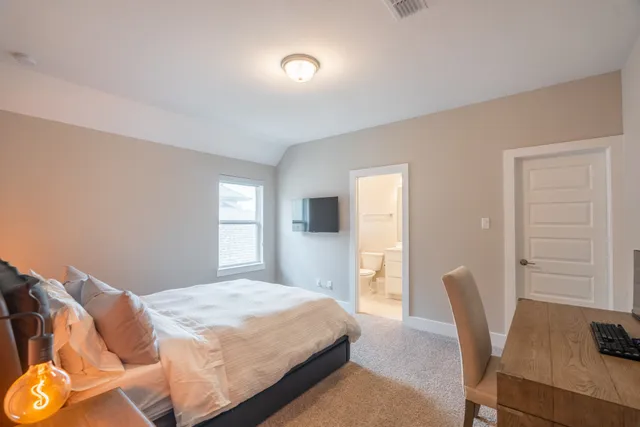 a bedroom with a bed and furniture