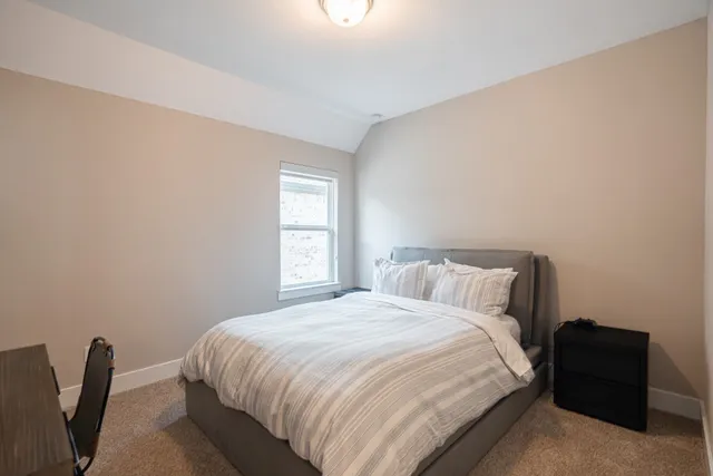 a bedroom with a bed and a chair