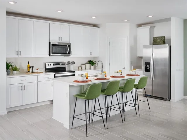 a kitchen with white cabinets stainless steel appliances and sink