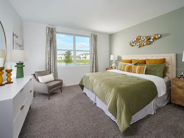 a spacious bedroom with a bed and a couch