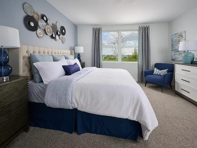 a bedroom with a bed couch and a window