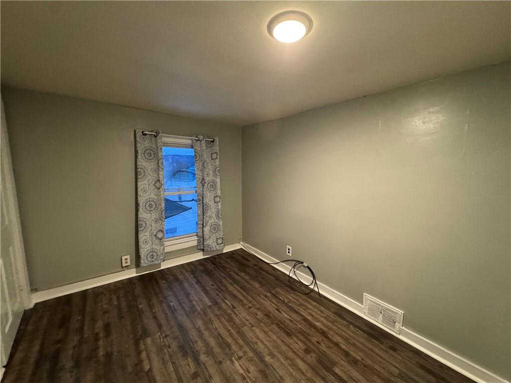 238-242 Philadelphia Street Indiana, PA 15701 - Photo 11 of 25 an empty room with wooden floor and window