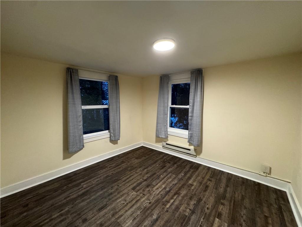 238-242 Philadelphia Street Indiana, PA 15701 - Photo 12 of 25 an empty room with wooden floor and entrance