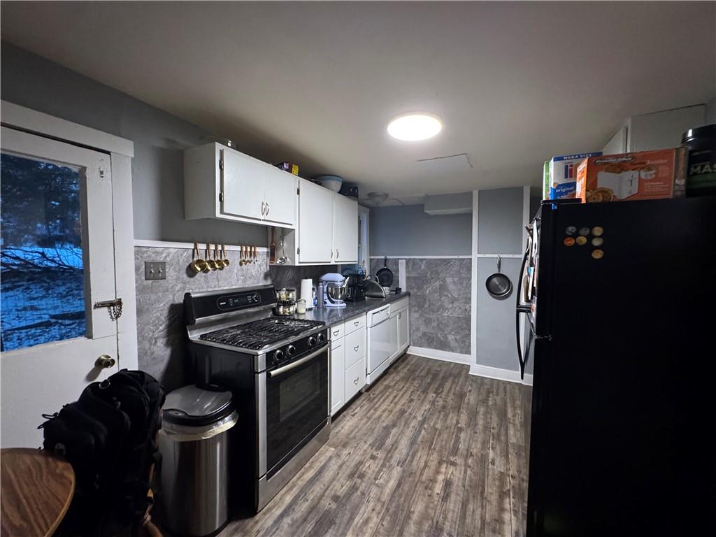 238-242 Philadelphia Street Indiana, PA 15701 - Photo 13 of 25 a kitchen with granite countertop a stove and a refrigerator
