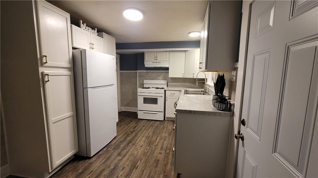 238-242 Philadelphia Street Indiana, PA 15701 - Photo 3 of 25 a kitchen with a refrigerator a stove top oven and a refrigerator