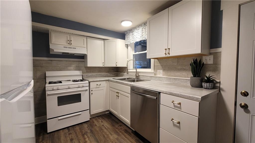 238-242 Philadelphia Street Indiana, PA 15701 - Photo 4 of 25 a kitchen with granite countertop white cabinets and white appliances