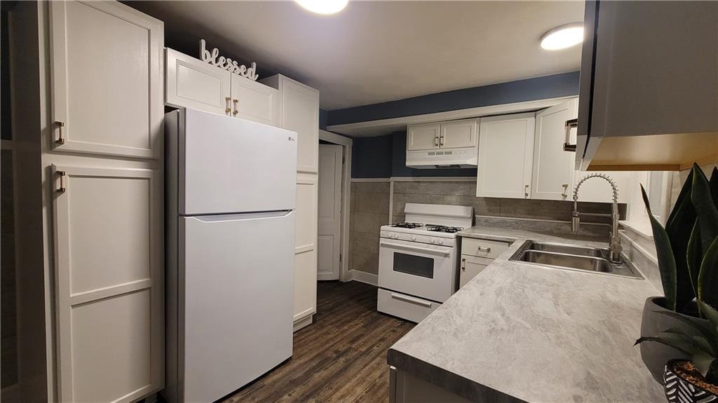 238-242 Philadelphia Street Indiana, PA 15701 - Photo 5 of 25 a kitchen with a refrigerator a stove and a sink