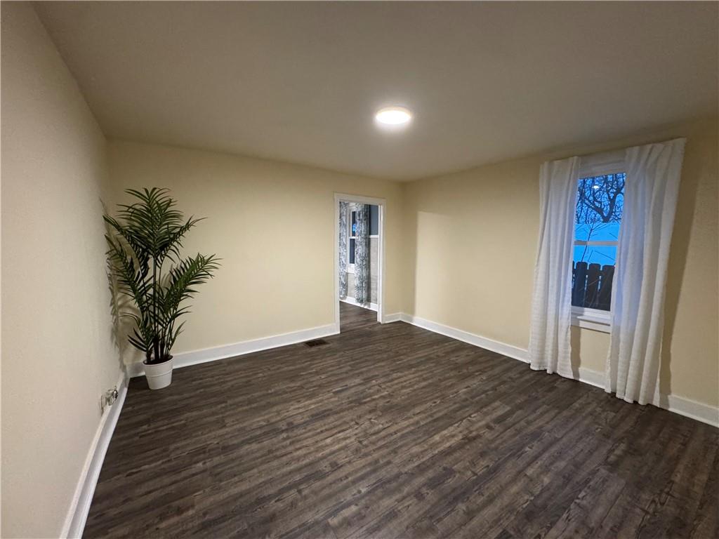 238-242 Philadelphia Street Indiana, PA 15701 - Photo 7 of 25 a view of an empty room with wooden floor and a window