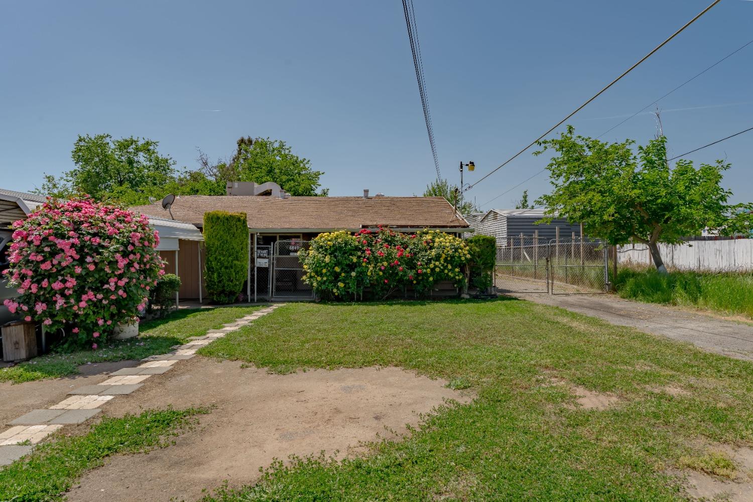 a front view of a house with a garden