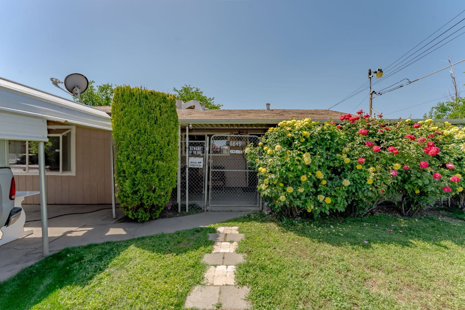 6849 26th Street Rio Linda, CA 95673 - Photo 2 of 56 a front view of a house with a yard