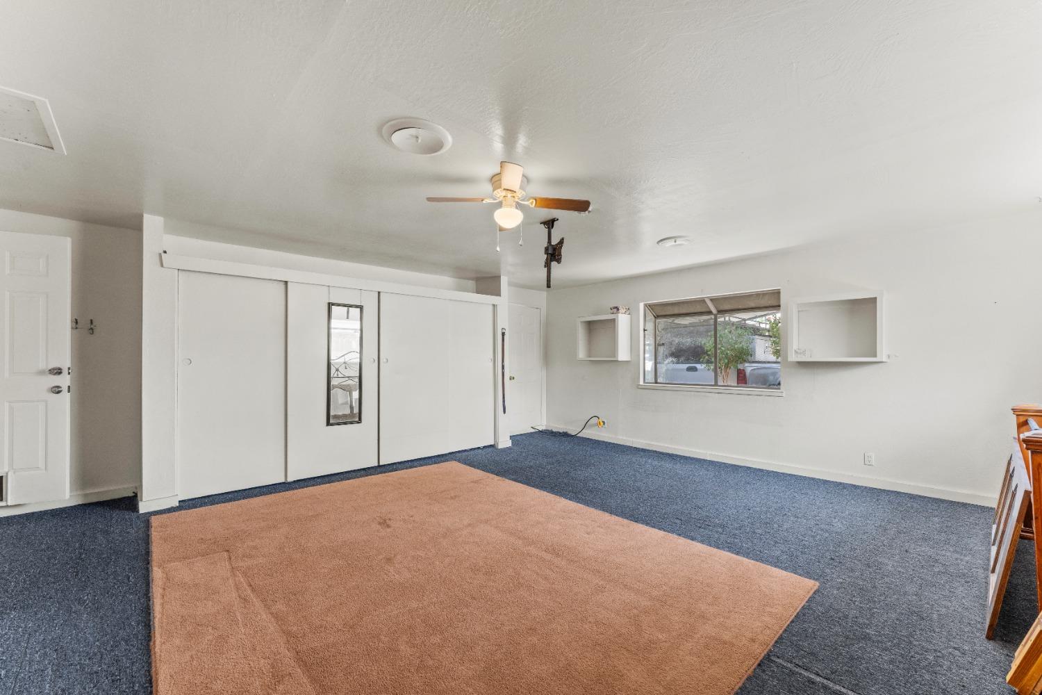6849 26th Street Rio Linda, CA 95673 - Photo 21 of 56 a view of a big room with windows and chandelier fan