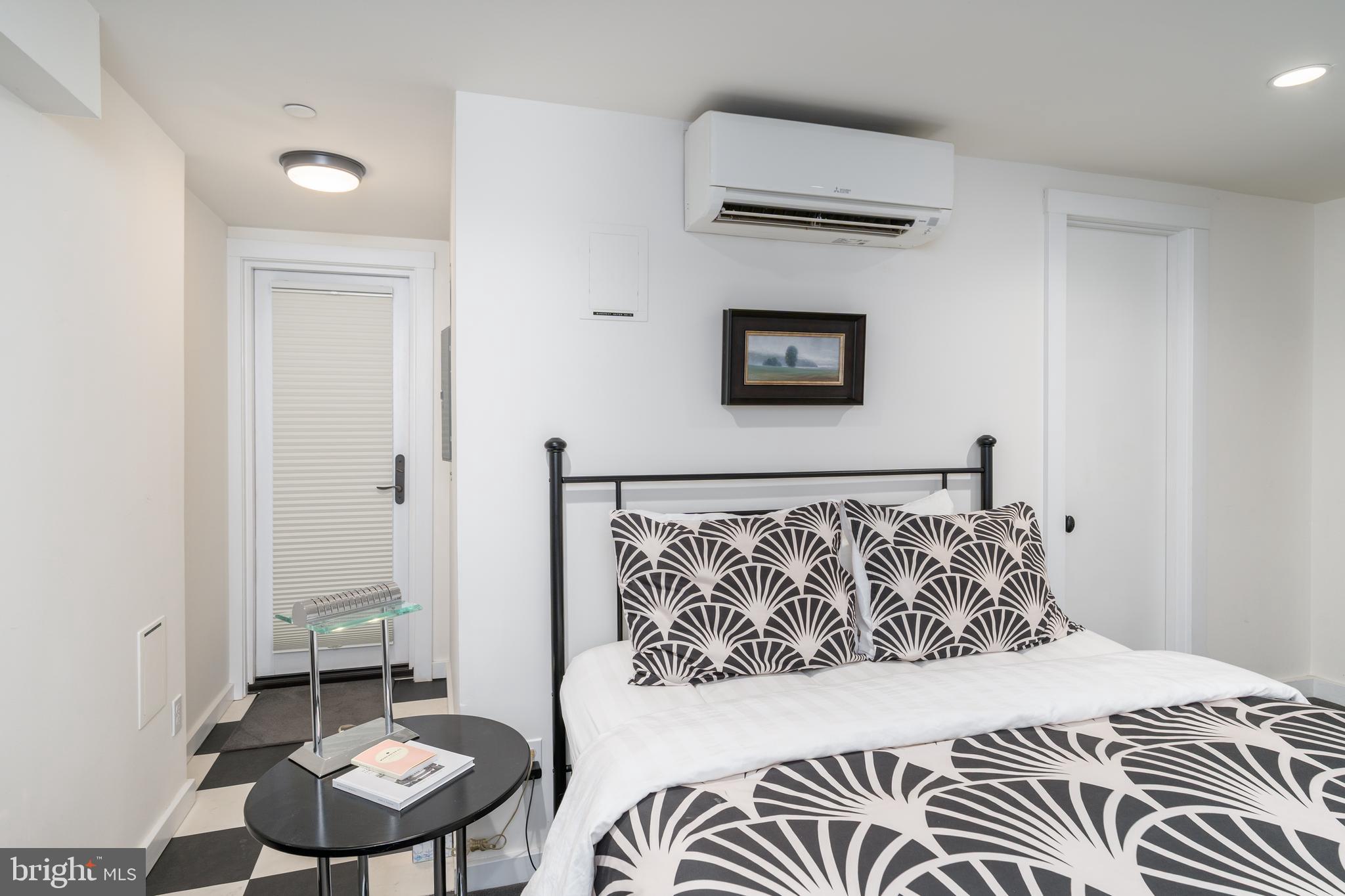 1737 Church Street Northwest Washington, DC 20036 - Photo 55 of 58 a bedroom with a bed and a chair with potted plant