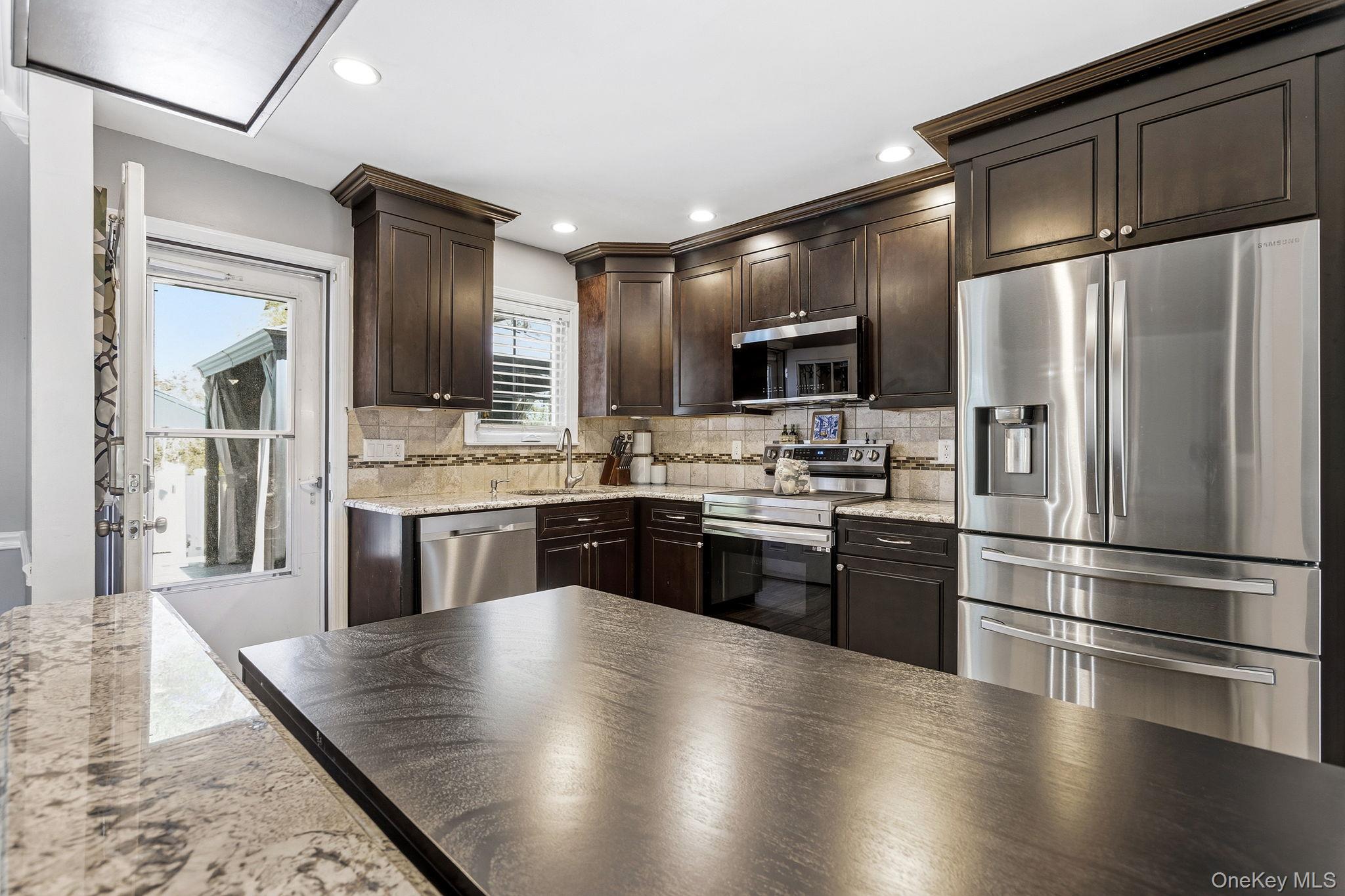 56 Tanager Road Mahopac, NY 10541 - Photo 9 of 30 a large kitchen with stainless steel appliances wooden floor and a refrigerator