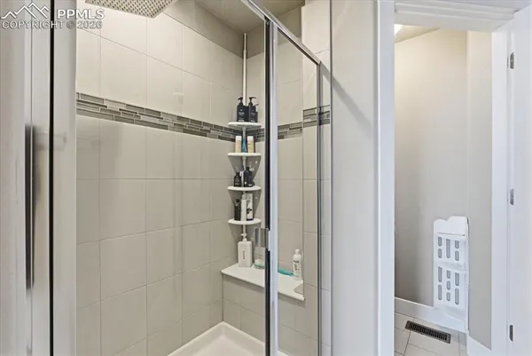 a bathroom with a glass shower door