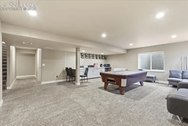 a living room with furniture a table and a large window