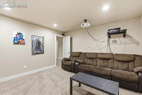 a living room with furniture a couch and painting on the wall