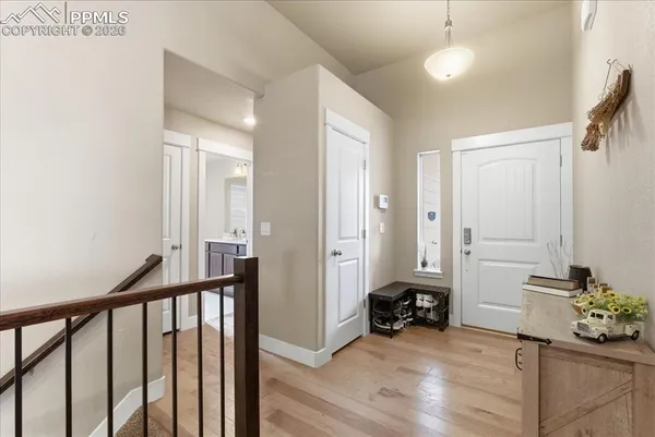 a view of a hallway to a livingroom with furniture