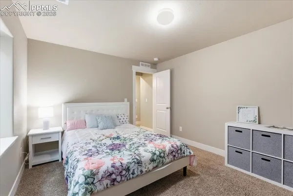 a bedroom with a large bed and a dresser
