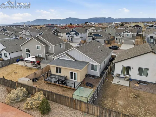 an aerial view of a house with a big yard