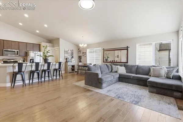 a living room with lots of furniture and kitchen view