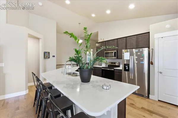 a kitchen with a table and refrigerator
