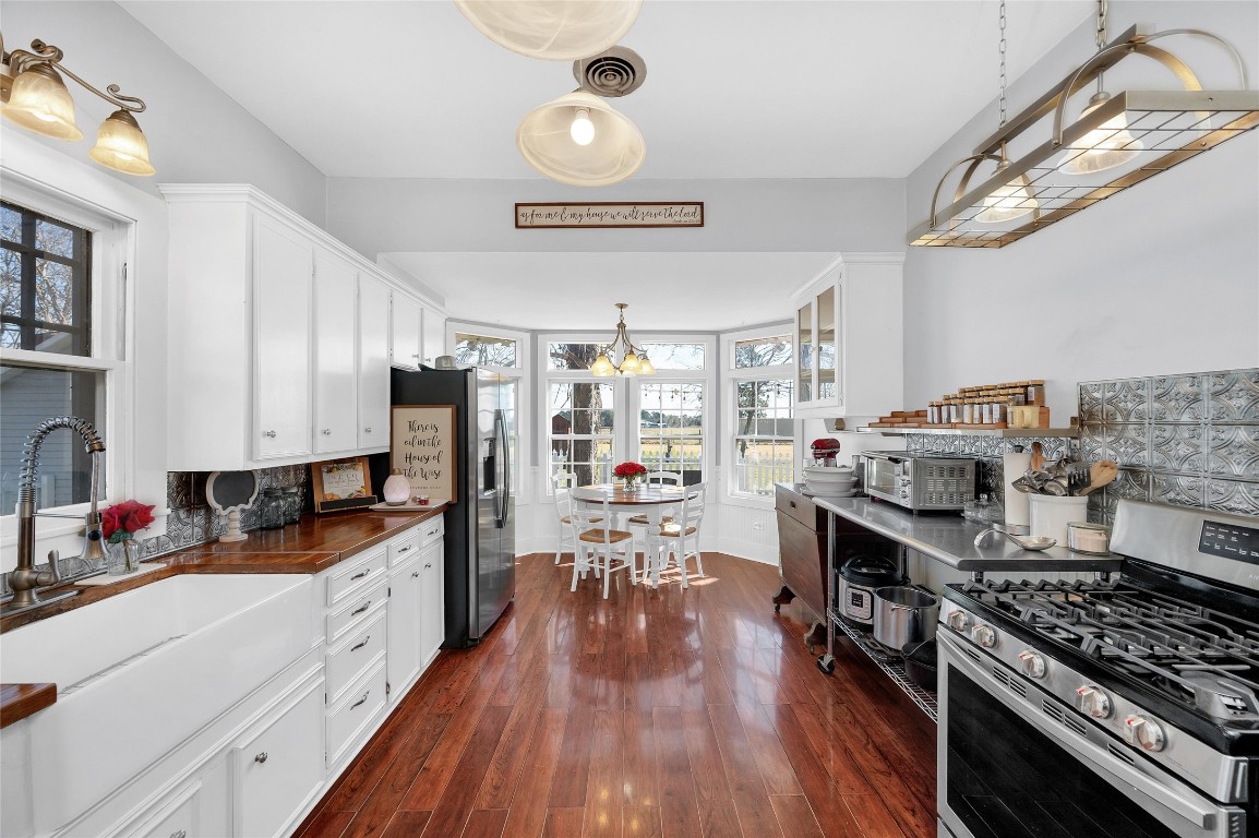 10152 Farm To Market Road 949 Cat Spring, TX 78933 - Photo 24 of 45 a kitchen with stove and wooden floor