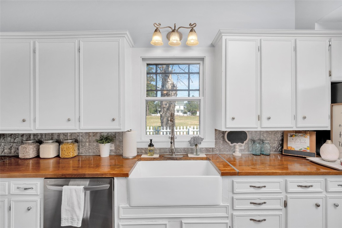 10152 Farm To Market Road 949 Cat Spring, TX 78933 - Photo 26 of 45 a kitchen with granite countertop white cabinets and sink
