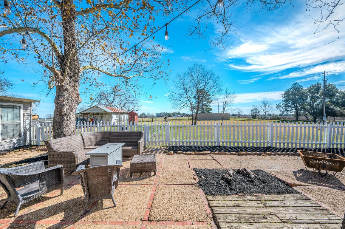 10152 Farm To Market Road 949 Cat Spring, TX 78933 - Photo 9 of 45 a view of a patio with two couches and a table and chairs with wooden floor and fence