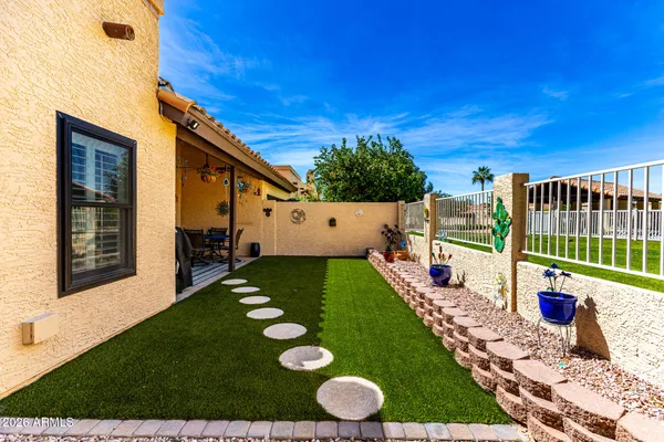 a view of a backyard with plants and patio