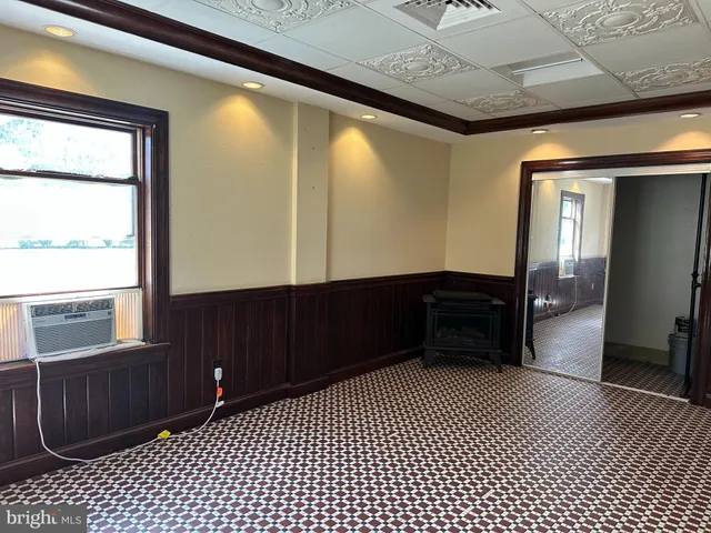 a room with a large window and furniture