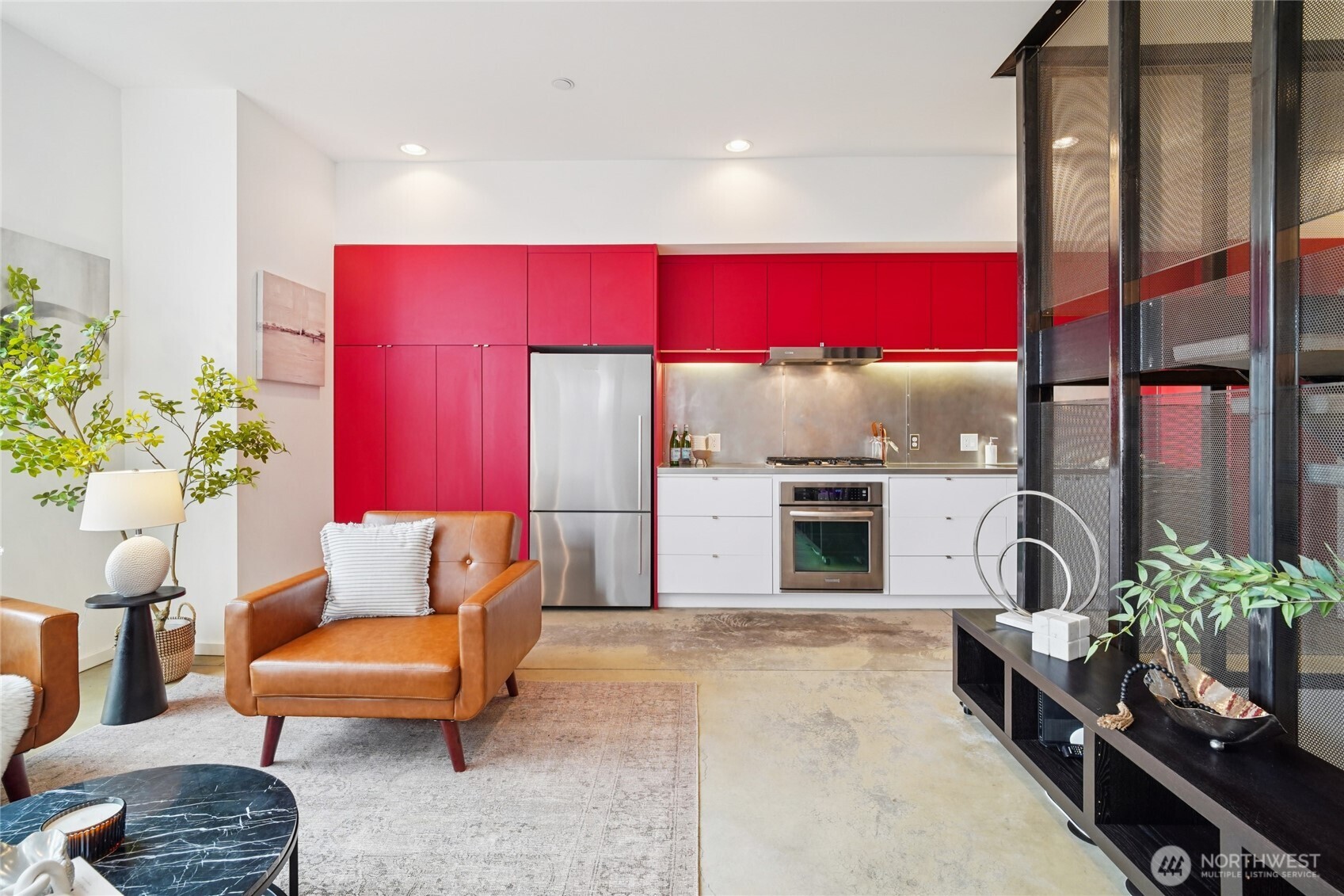 a living room with furniture kitchen appliances and a fireplace