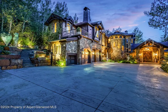 a bedroom with two beds and a flat screen tv