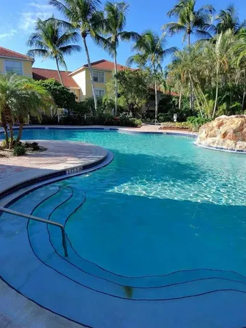 a view of a swimming pool with a yard