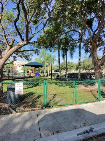 a view of a park with large trees