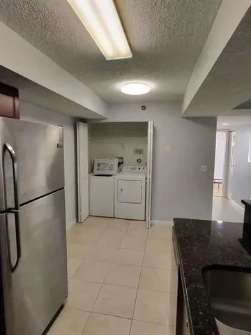 a kitchen with a sink appliances and cabinets