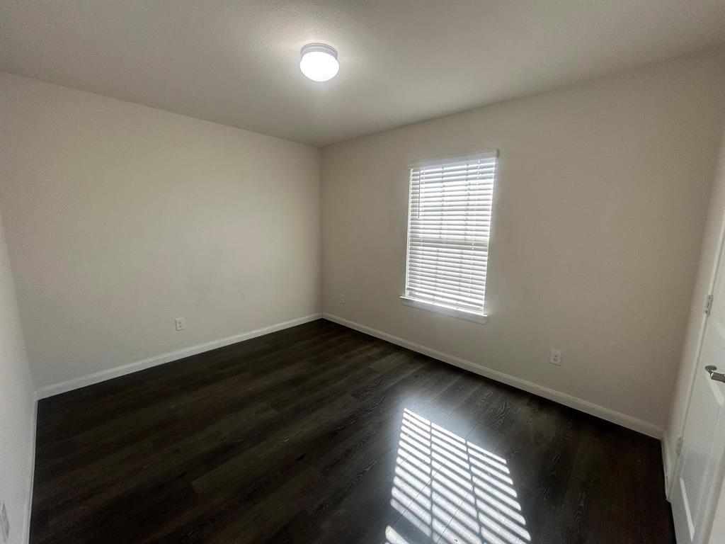 602 Range Drive Princeton, TX 75407 - Photo 13 of 19 an empty room with wooden floor and windows